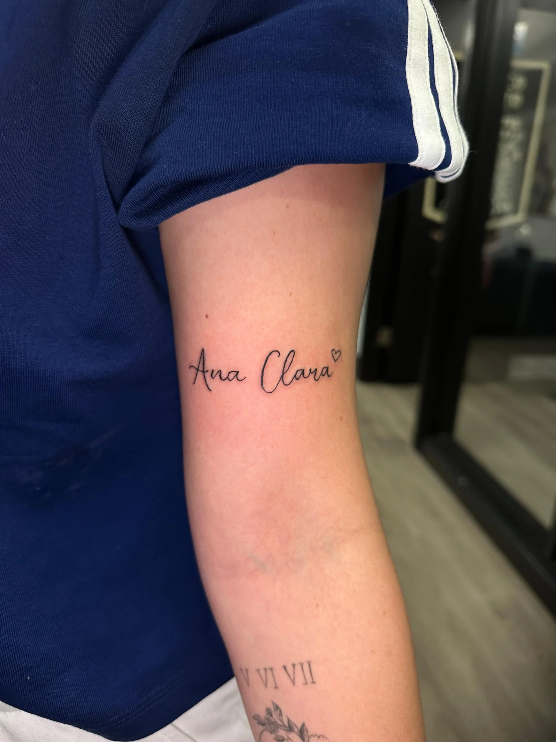Ana Clara name tattoo fine cursive script inner bicep ink Boca Raton