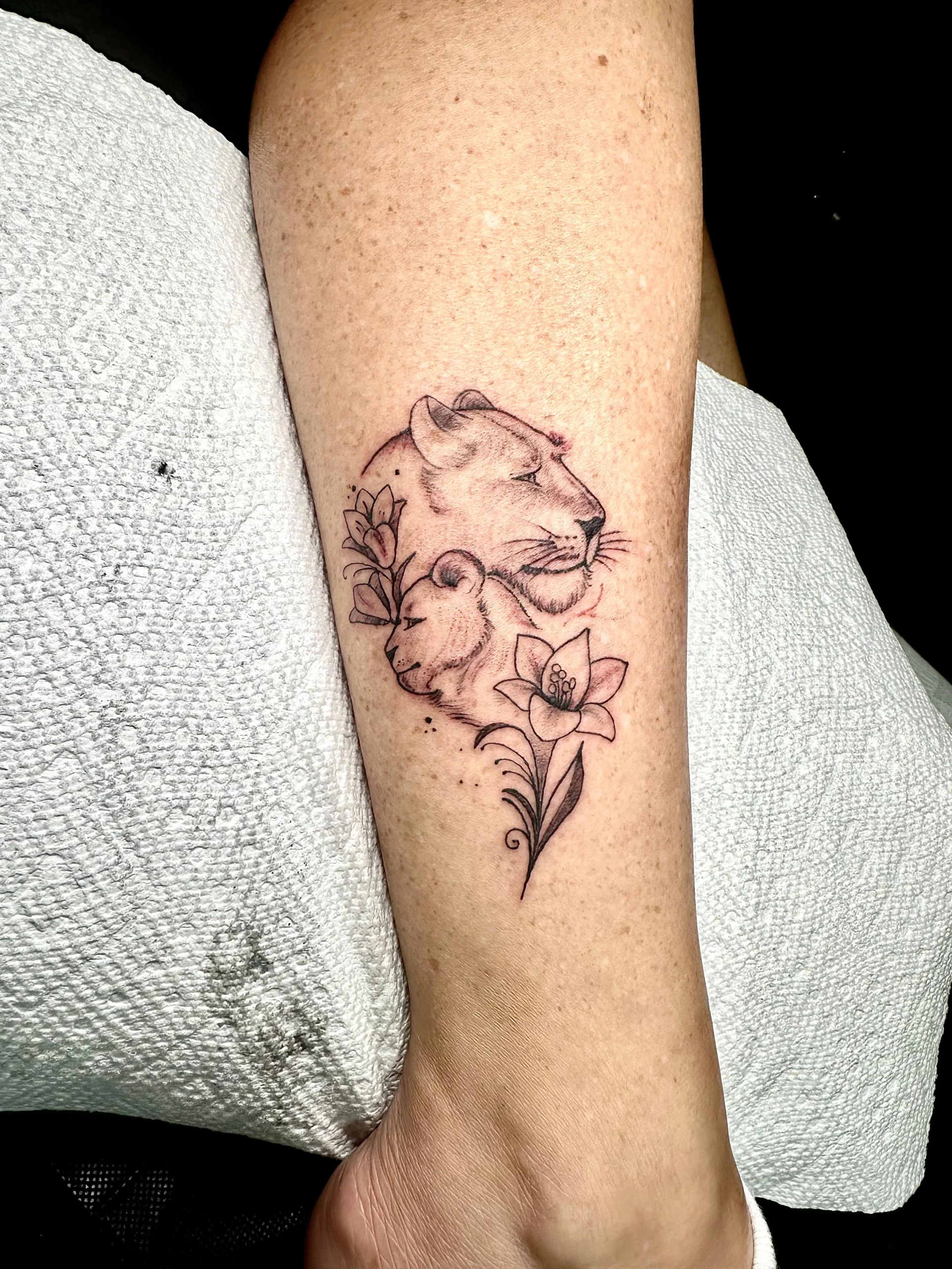 Lioness and cub with lily flower tattoo fine line family love ink Boca Raton
