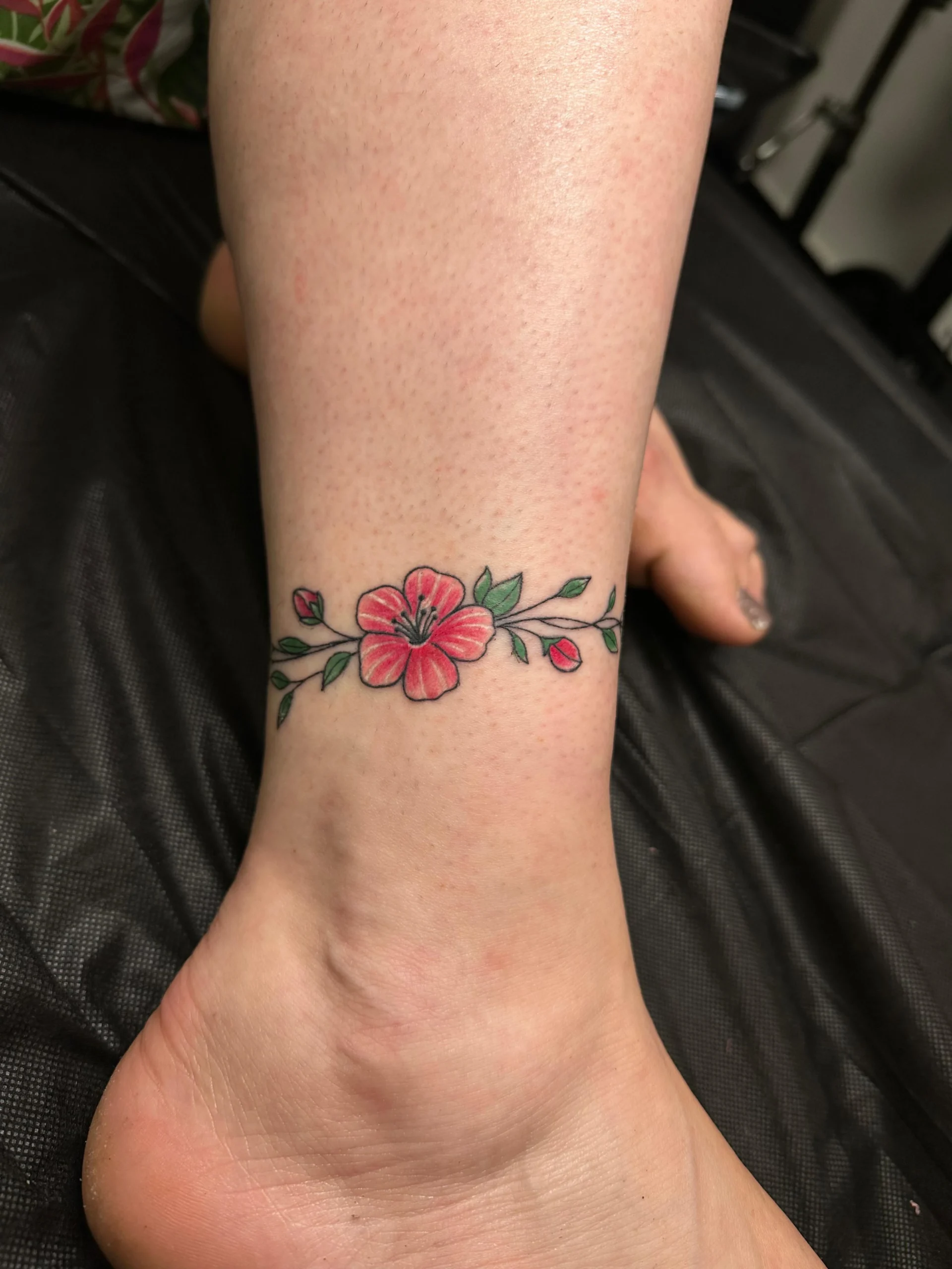 Floral anklet tattoo red hibiscus flower band ankle placement Boca Raton FL