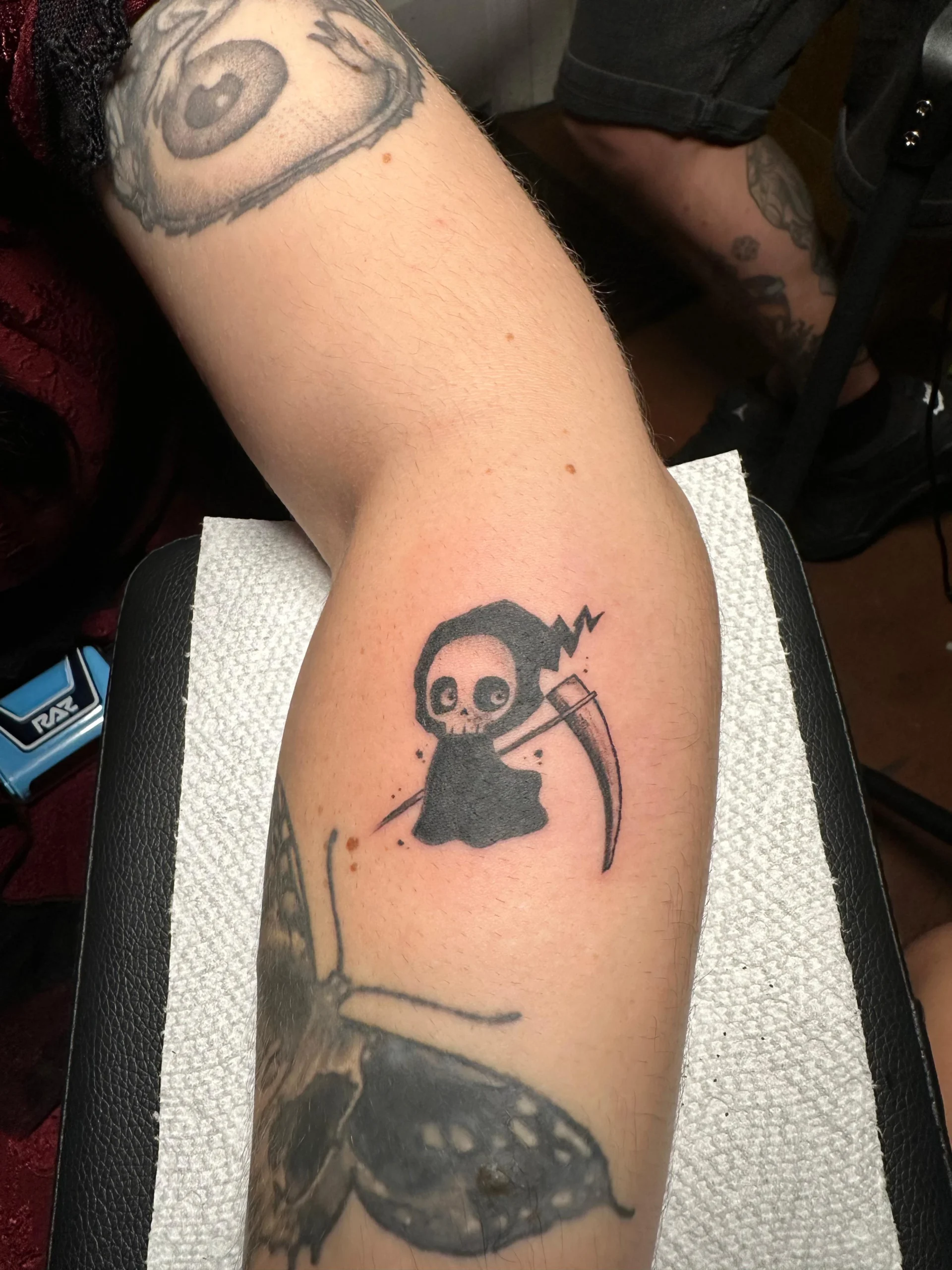 Cute cartoon Grim Reaper tattoo small fun ink design Boca Raton tattoo shop