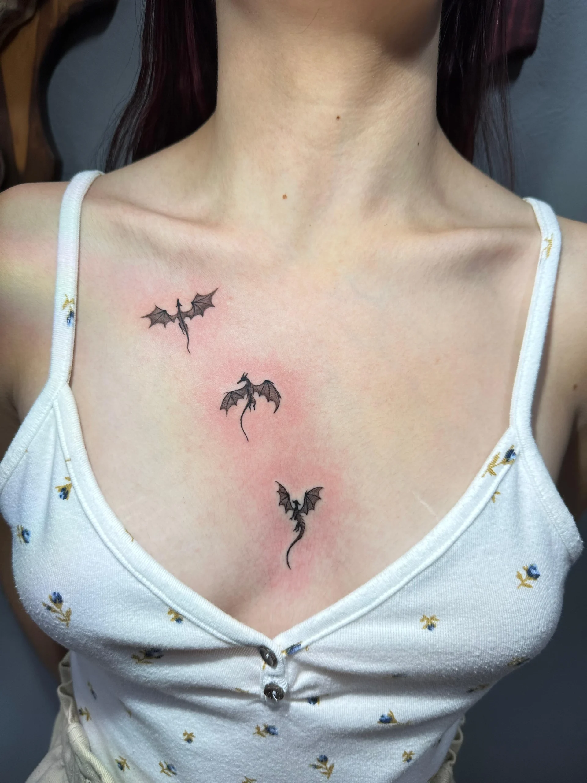 Tiny flying dragons tattoo fine line collarbone placement Boca Raton Florida