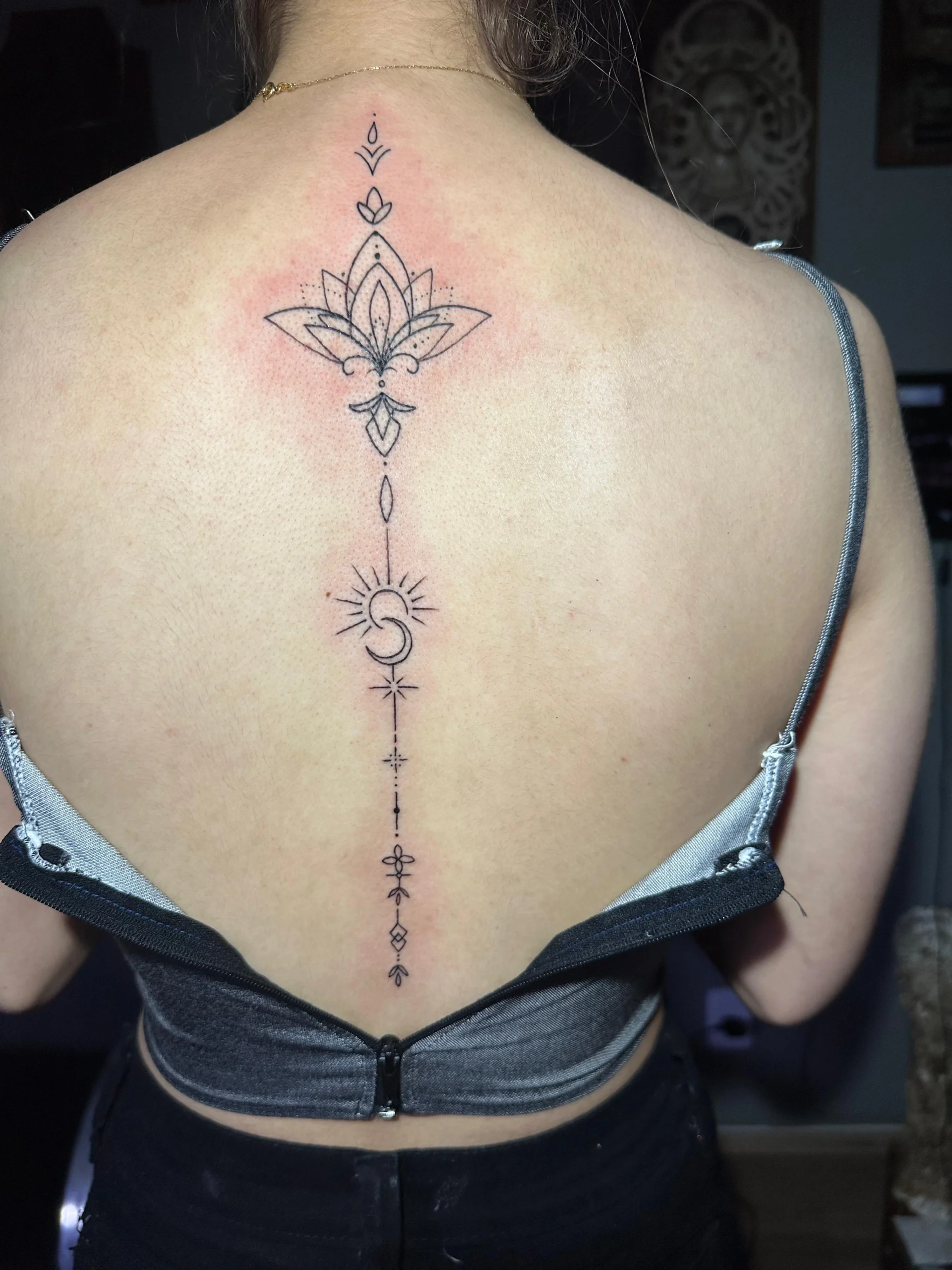 Fine line ornamental spine tattoo lotus and unalome design back ink Boca Raton