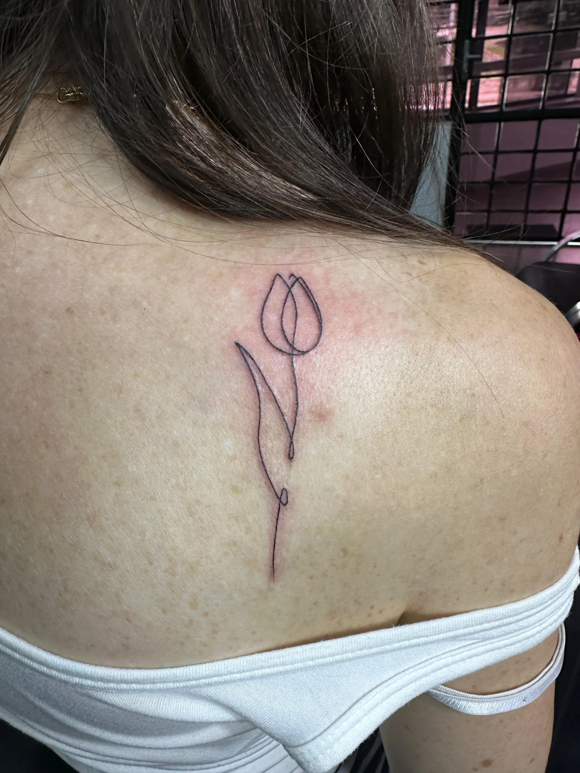 Single line tulip flower tattoo minimalist shoulder design Boca Raton artist