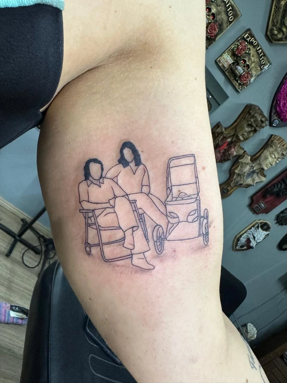Minimalist outline tattoo of couple with baby stroller family memory Boca Raton artist