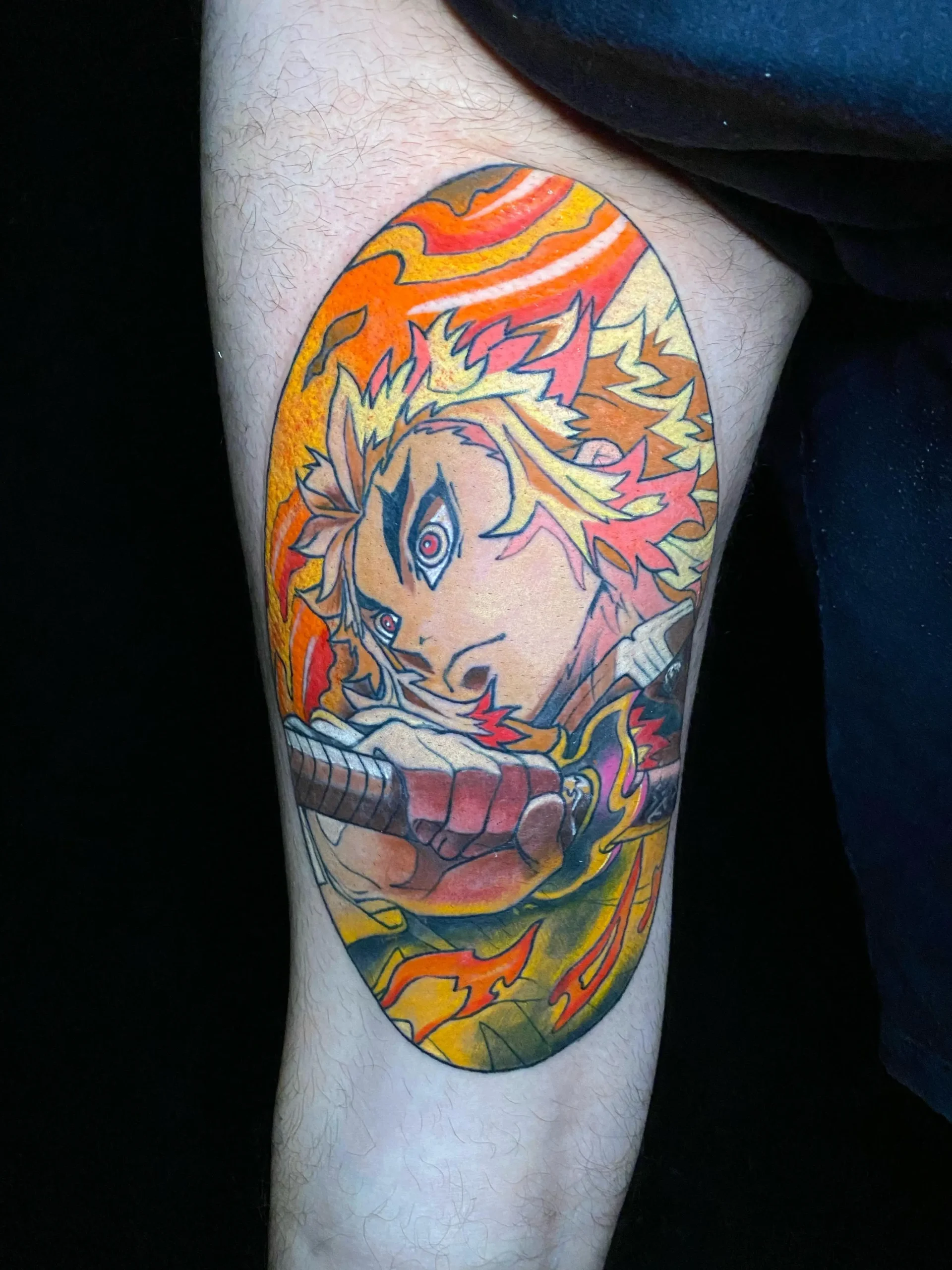 Vibrant Demon Slayer anime tattoo featuring Rengoku with flame effects on the leg, colorful pop culture ink in Boca Raton, Florida.