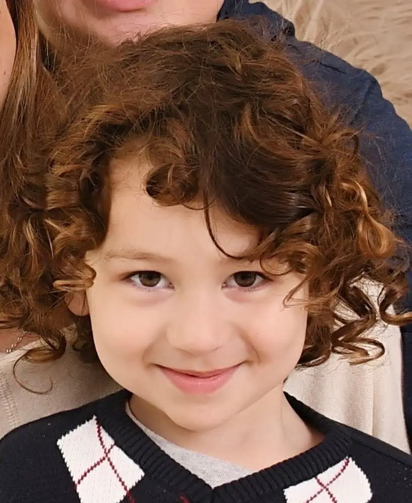 Hyper-realistic color portrait tattoo of a smiling young boy named Matheus, expert memorial and family ink in Boca Raton, Florida.