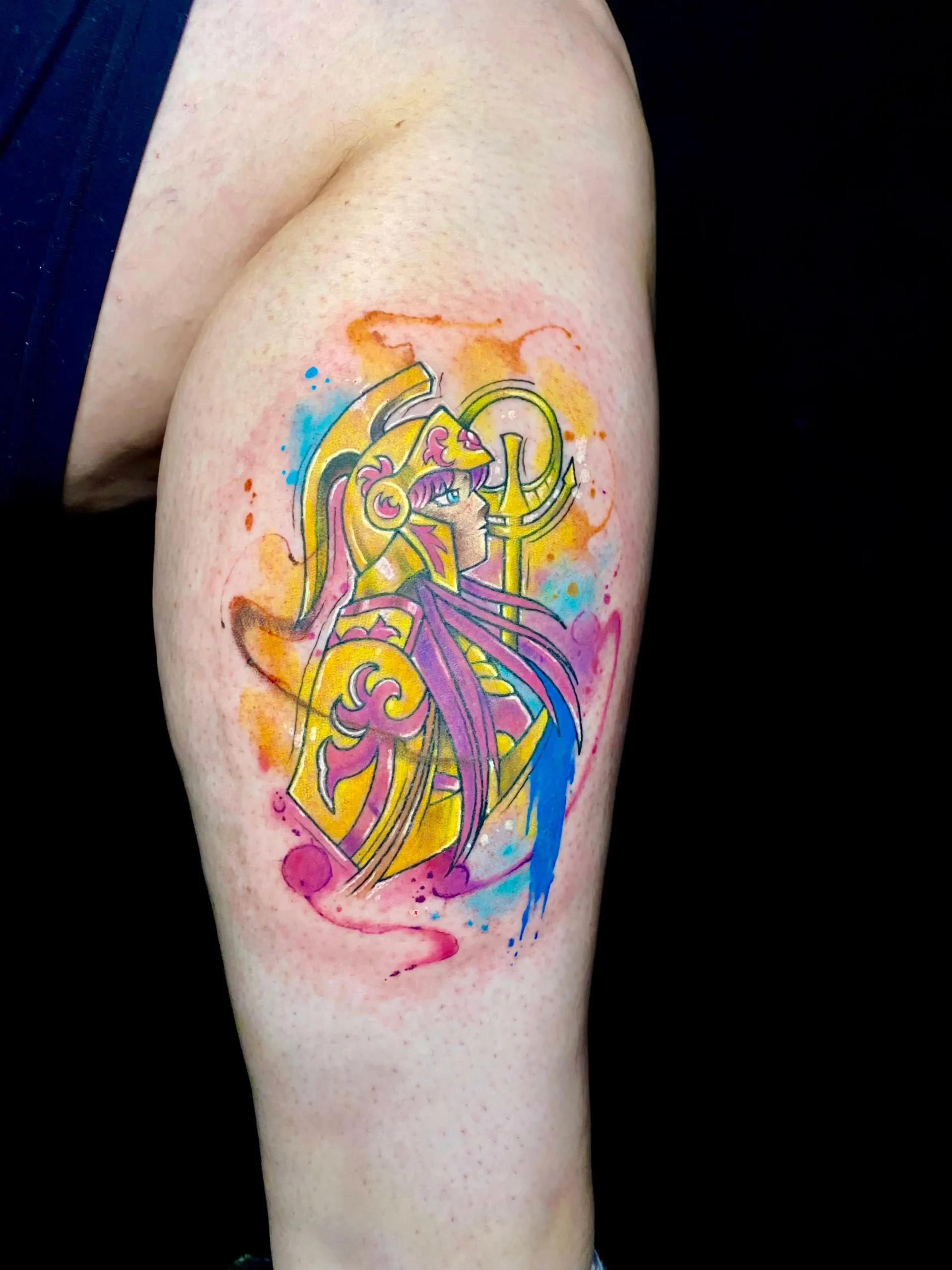 Saint Seiya anime tattoo featuring a golden armor character with watercolor background, custom manga ink in Boca Raton, Florida.