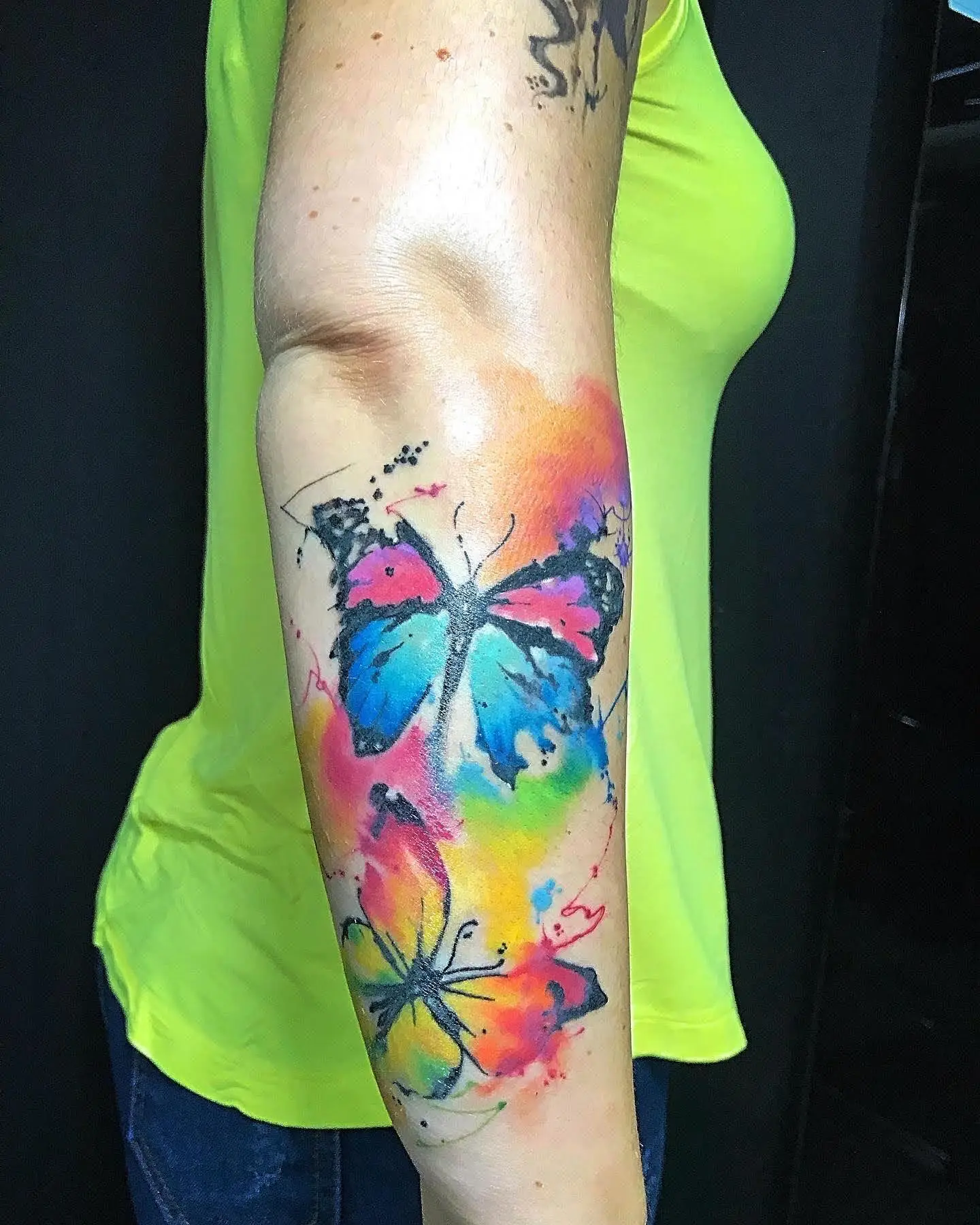 Watercolor butterfly and flower tattoo forearm placement colorful ink Boca Raton FL