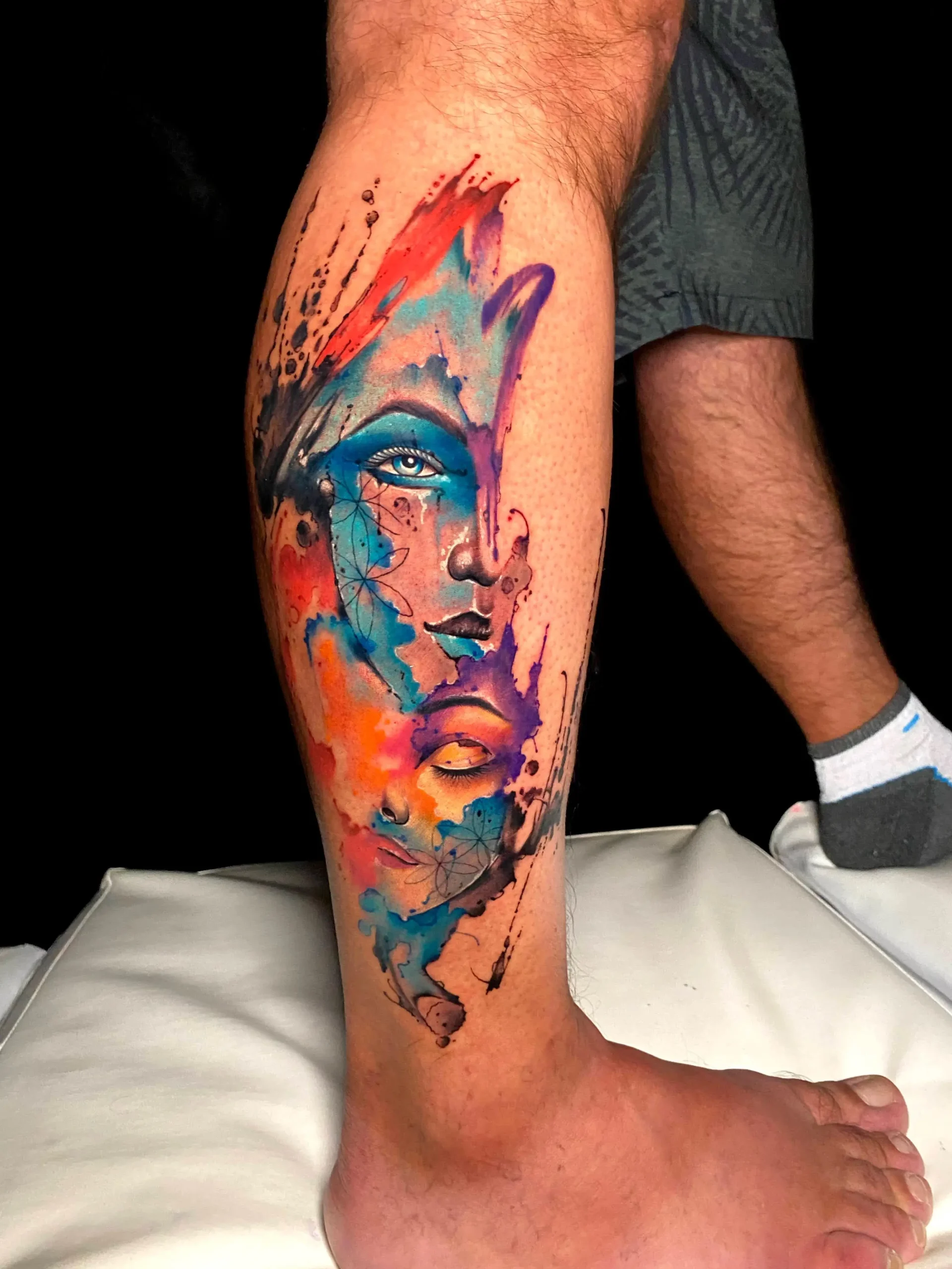 Abstract surrealist woman face tattoo vibrant watercolor leg sleeve Boca Raton artist