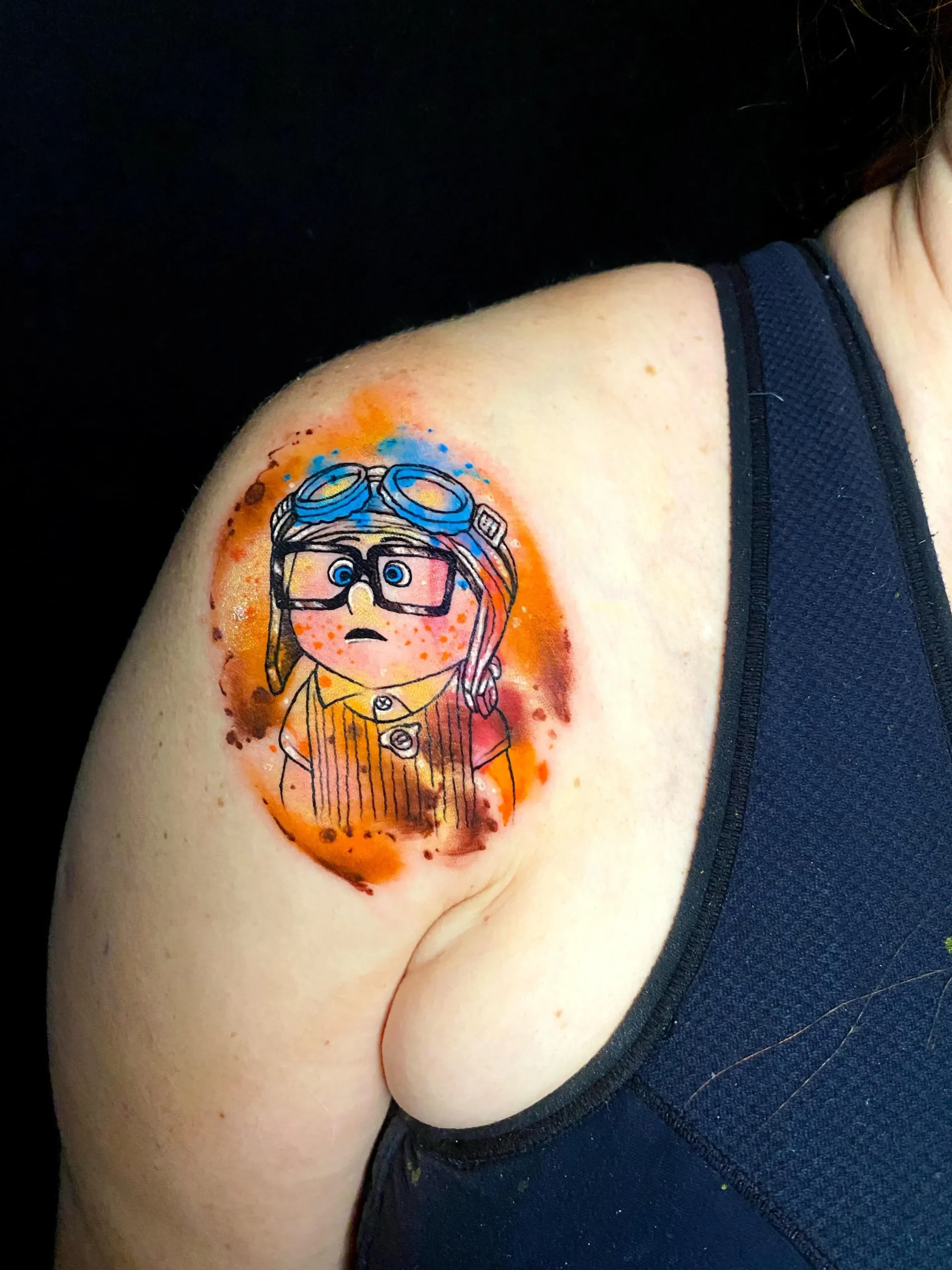 Pixar Up movie tattoo young Carl character watercolor style shoulder ink Boca Raton