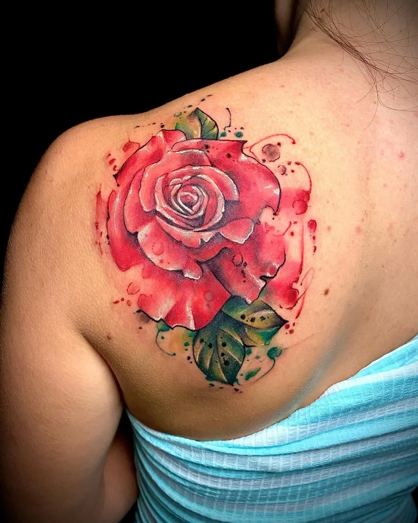 Realistic watercolor red rose tattoo on shoulder blade floral back piece Boca Raton FL