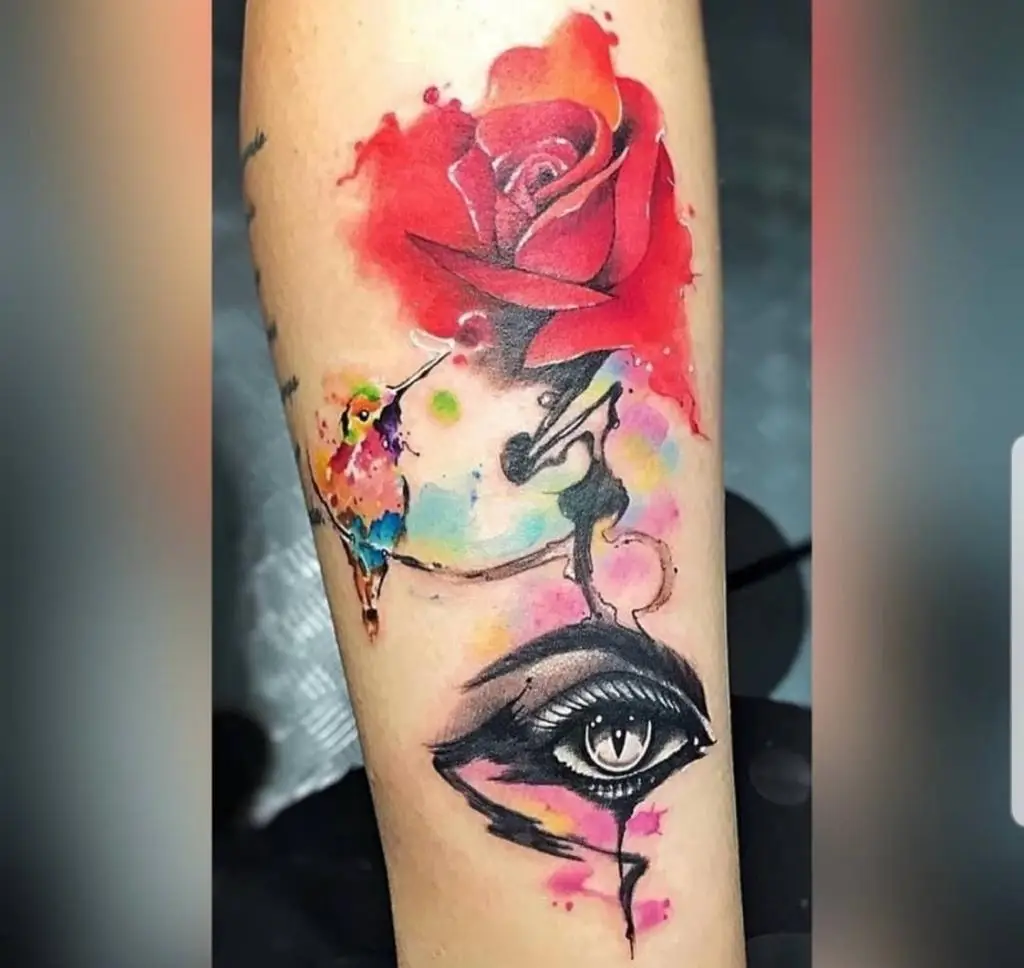 Surreal tattoo sleeve featuring a realistic eye, watercolor red rose, and abstract elements, custom art by a Boca Raton tattoo studio.